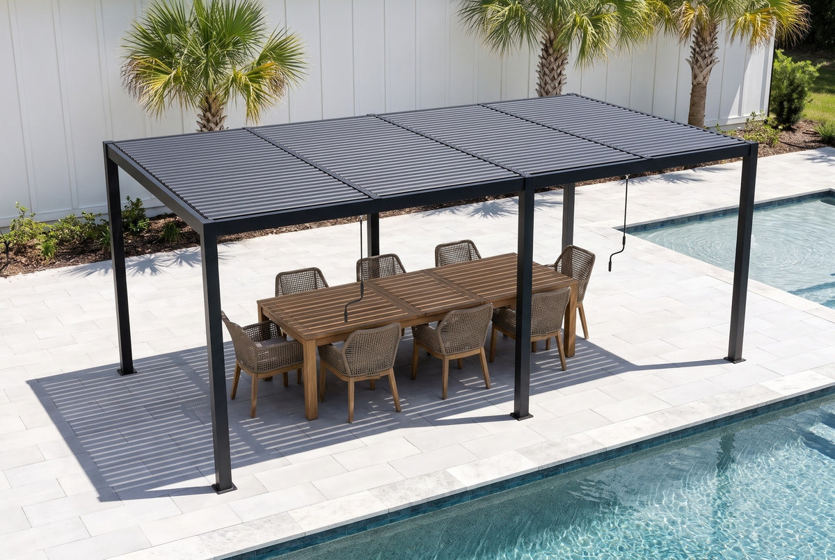 Regalbuto black louvered pergola over a teak dining table for eight on pale pavers beside a pool in Tampa, a white board-and-batten wall and palms behind (furniture not included)