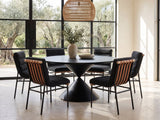 Rende 59-Inch Round Black Oak Hourglass Dining Set with 6 Chairs in a sunlit villa dining area with olive trees outside