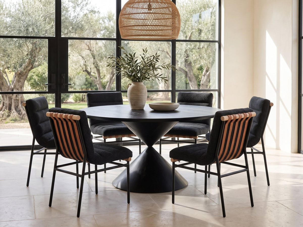 Rende 59-Inch Round Black Oak Hourglass Dining Set with 6 Chairs in a sunlit villa dining area with olive trees outside