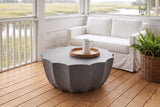 Ribera speckled gray coffee table on heart-pine boards on a screened Lowcountry porch near Charleston, a white slipcovered sofa, whitewashed shiplap and the marsh beyond (sofa, tray and pitcher not included)