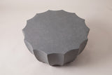 The Ribera coffee table seen from above: the flat speckled gray top with fourteen points around its scalloped edge