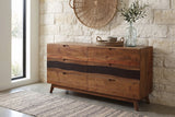 Rionero acacia sideboard against a cream limestone wall in an Austin entryway with a polished concrete floor and a woven runner