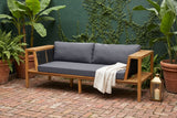 Riposto acacia daybed sofa in a New Orleans Garden District courtyard with a deep green wall, climbing fig and red brick pavers (throw and lantern not included)