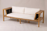 The Riposto acacia daybed sofa with cream cushions and black rope arm panels, three-quarter view on a light studio backdrop