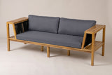 The Riposto acacia daybed sofa with grey cushions and black rope arm panels, three-quarter view on a light studio backdrop
