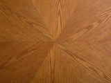 Close-up of the Rivoli 30-Inch Round Carved Wood Drum Coffee Table: the sunburst ash grain of the round top