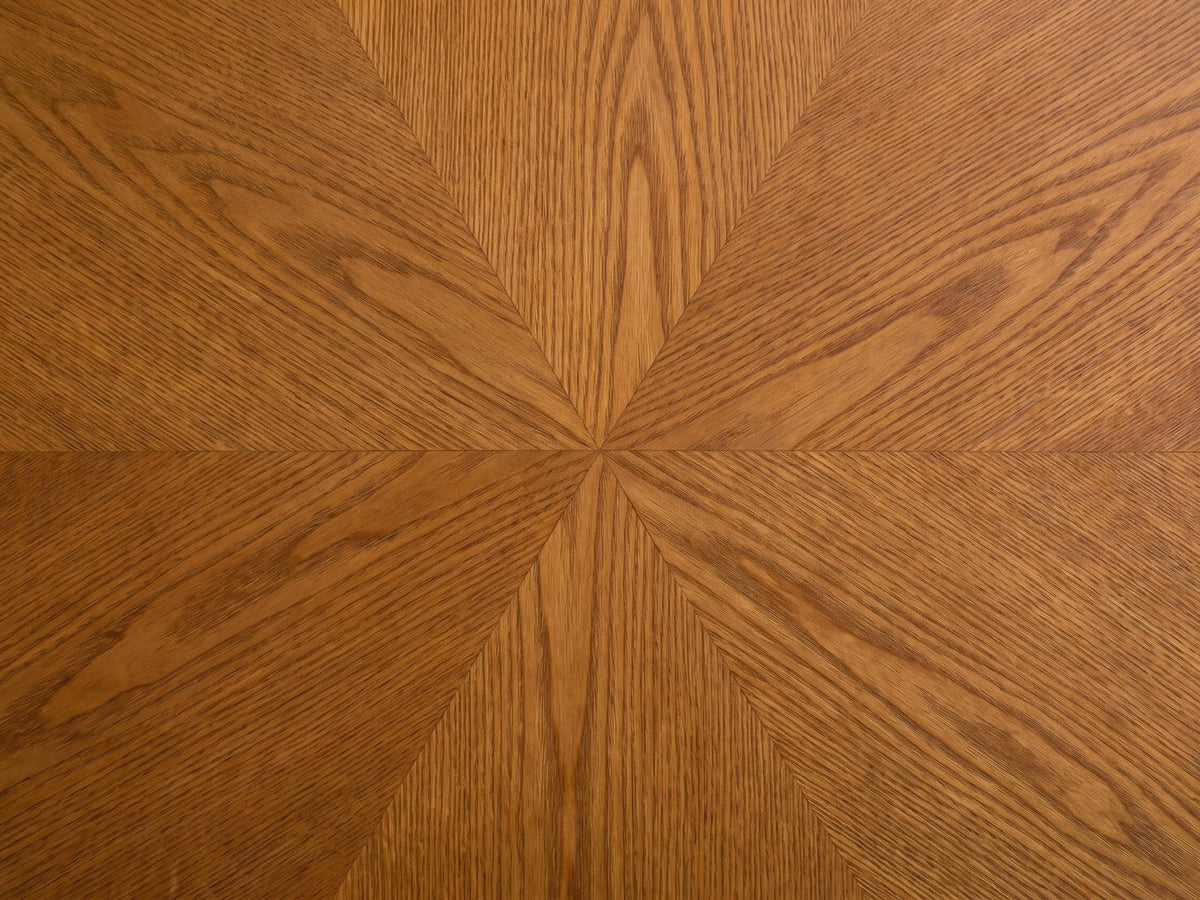 Close-up of the Rivoli 30-Inch Round Carved Wood Drum Coffee Table: the sunburst ash grain of the round top
