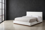 Roccascalegna white boucle bed against a charcoal limewash wall in a Chicago loft, a tall black steel window at the left
