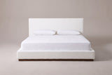 Roccascalegna bed in white boucle with a white mattress and pillows (not included), front view