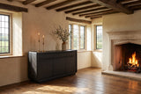 Rovito 64-Inch 3-Door 2-Drawer Burnished Black Ash Veneer Sideboard in an English country dining room