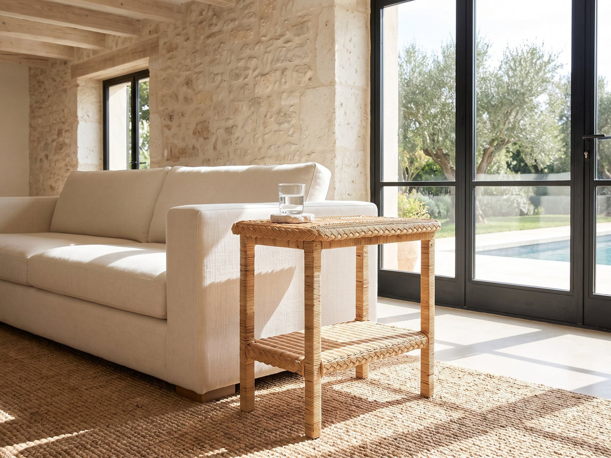 Rutigliano Braided Rattan Two-Tier Side Table beside a linen sofa in a poolside villa