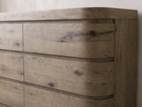 Close-up of the Sacile 70-Inch Weathered Natural Oak 6-Drawer Dresser: the right-hand drawer fronts bending around the rounded corner, in knotty oak veneer