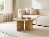 Salina Gold Beige Marble Coffee Table styled with books, a vase and a stone bowl in front of a cream sofa in a bright plaster room