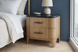 Samassi eucalyptus nightstand with a ceramic lamp in a Chicago bedroom with a navy wall and a pale oak herringbone floor