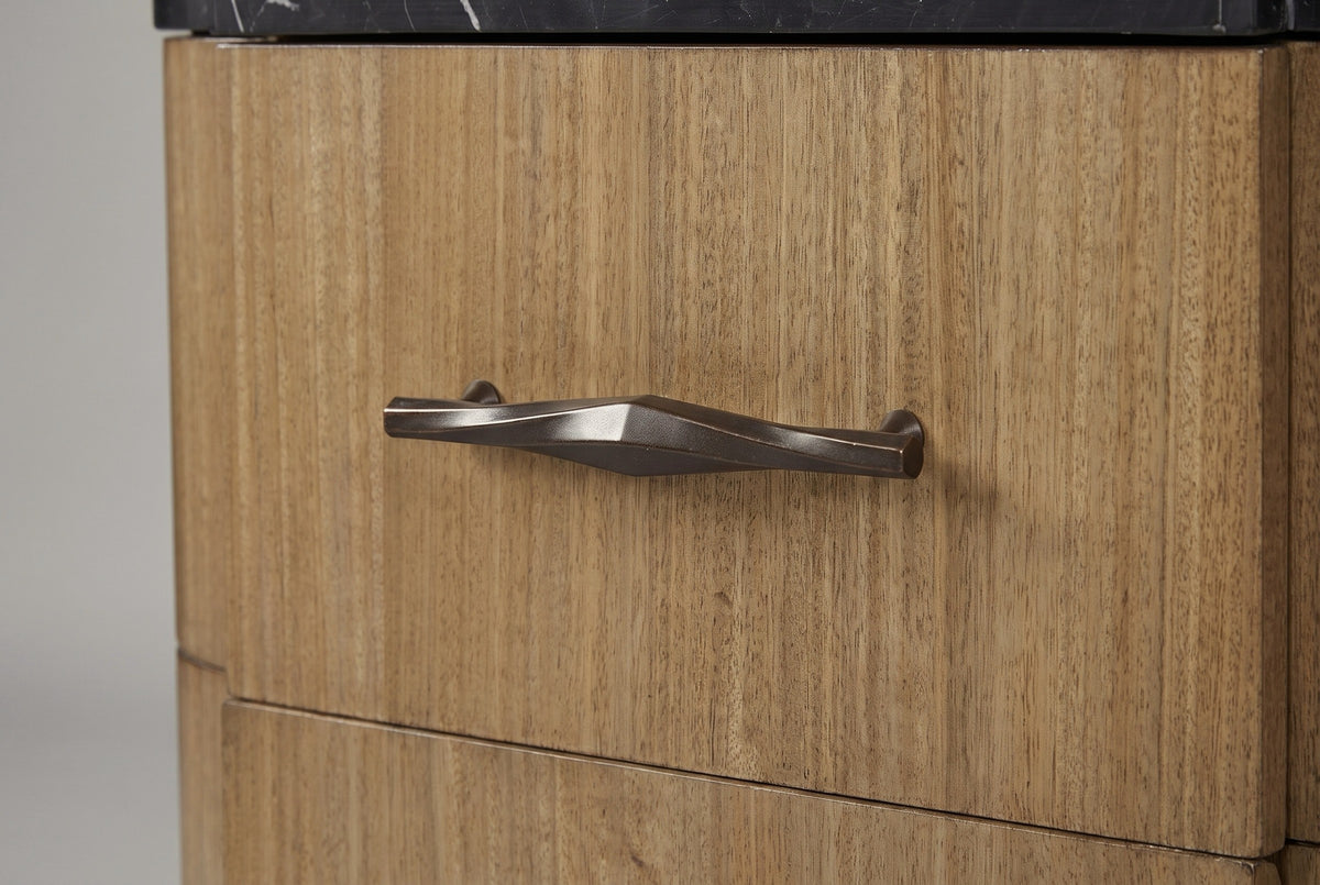 The upper drawer of the Samassi nightstand: a long bronze-finish bar pull with a diamond at its centre on striped eucalyptus veneer