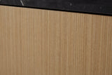 Close-up of the honey-tan eucalyptus veneer on the Samassi nightstand: a fine straight striped grain under the black stone top