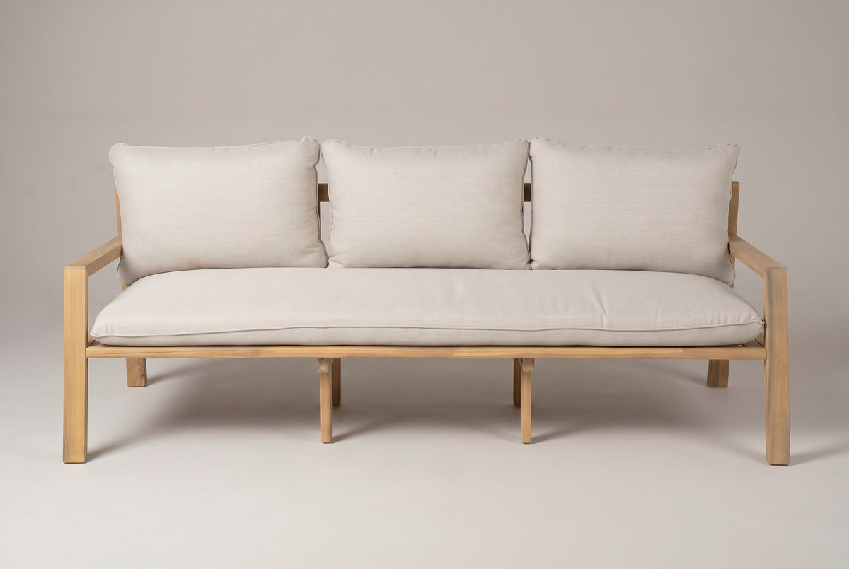 The Sambuca sofa seen straight from the front: one long seat cushion, three back cushions, two slim arms and the square legs