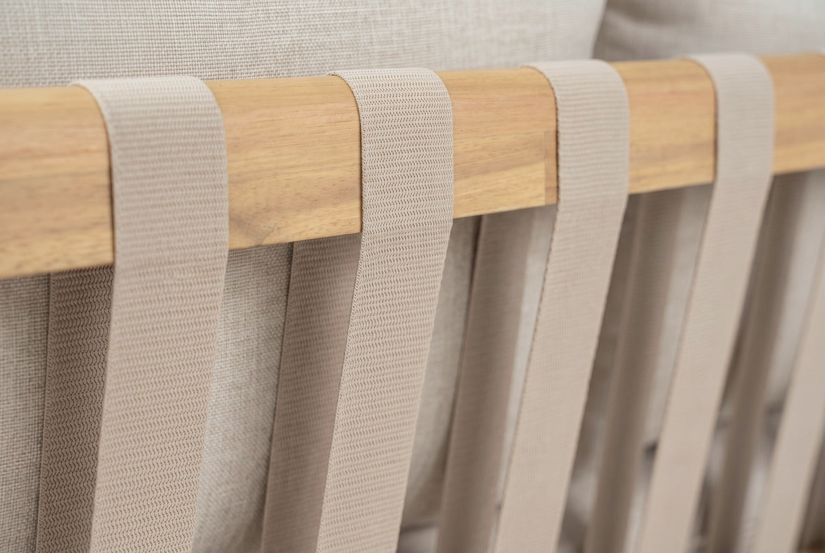 Close-up of the light taupe woven straps wrapped over the light teak acacia top rail of the Sambuca sofa