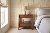 Sanluri walnut nightstand against a cream limestone wall in an Austin bedroom with a pale bleached oak floor