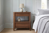 Sanluri walnut nightstand with a ceramic lamp in a Charleston bedroom with blue-grey board-and-batten panelling and white oak floors