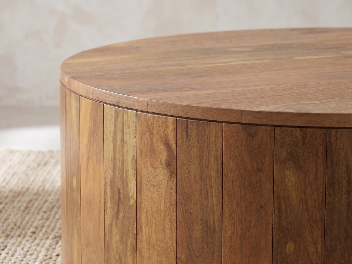 Close-up of the Sansepolcro Natural Mango Drum Coffee Table: the overhanging top over the vertical mango planks of the drum