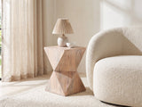 Santeramo Cerused Mango Faceted Side Table with a lamp and a ceramic bowl beside a cream boucle armchair in a bright plaster room