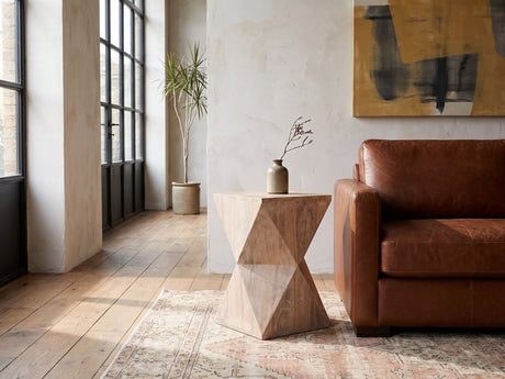 Santeramo Cerused Mango Faceted Side Table beside a leather sofa in an industrial loft