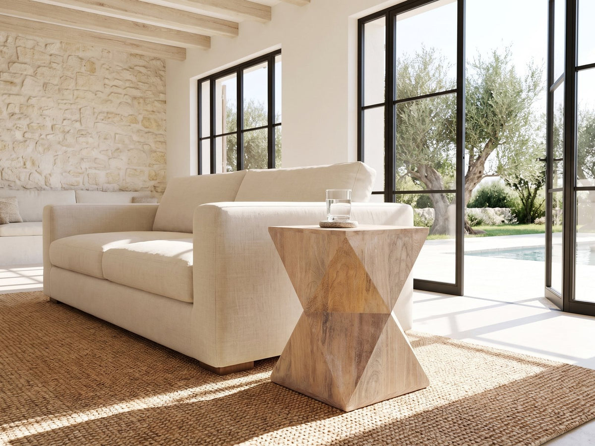 Santeramo Cerused Mango Faceted Side Table beside a linen sofa in a poolside villa