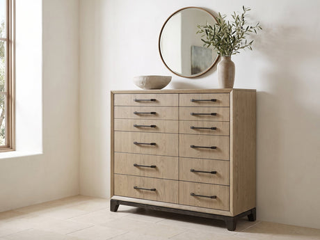 Sappada 54-Inch Caramel Oak and Cocoa 12-Drawer Chest under a round bronze mirror in a villa bedroom
