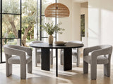 Saracena 54-Inch Round Ebony Oak Dining Set with 4 Boucle Chairs in a sunlit villa dining area with olive trees outside