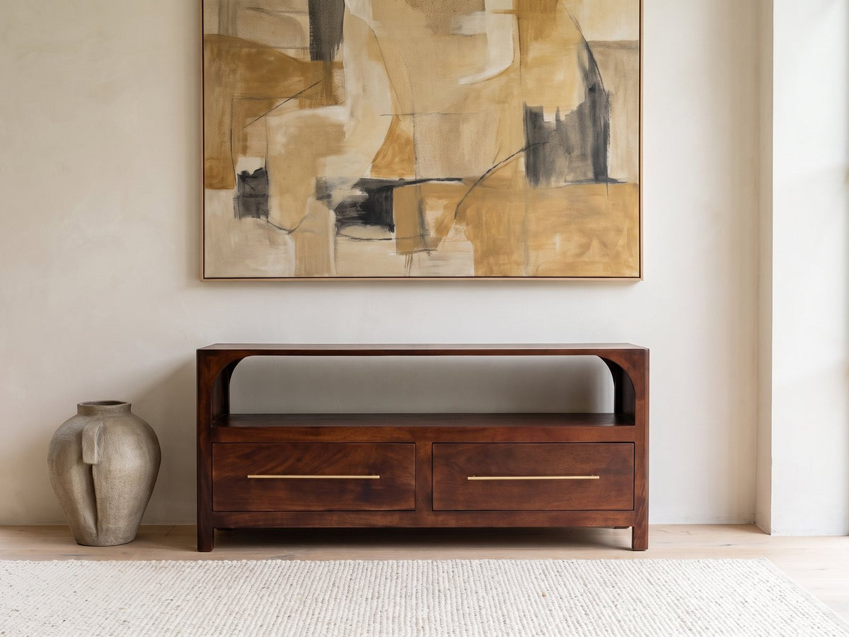 Sarzana 47-Inch Winewood Solid Mango Arched Media Console under a large abstract painting in a bright living room
