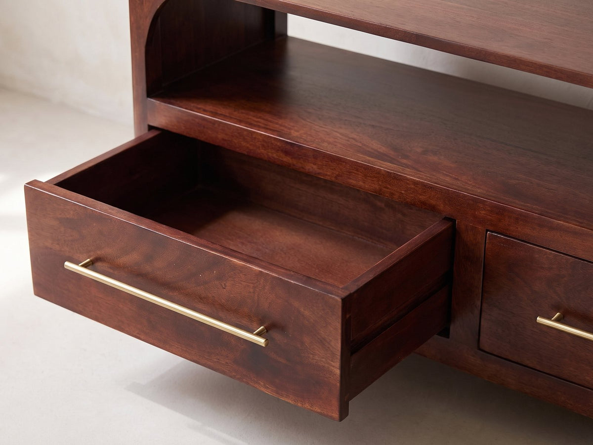 Close-up of the Sarzana 47-Inch Winewood Solid Mango Arched Media Console: an open solid mango drawer with its slim brass bar pull