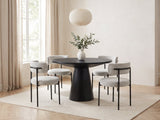 Savelli 47-Inch Round Black Oak Pedestal Dining Set with 4 Boucle Chairs in a bright plaster dining room with linen curtains