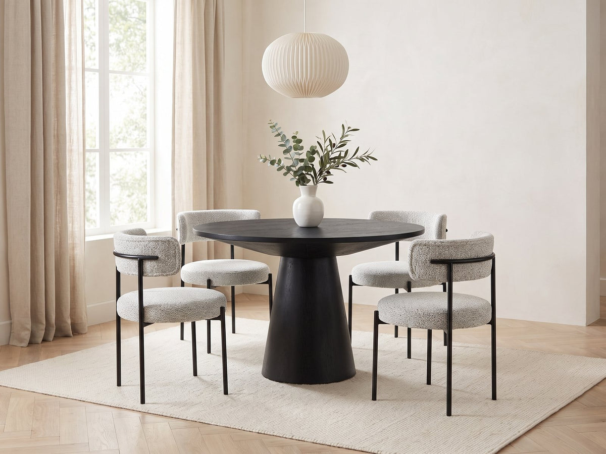 Savelli 47-Inch Round Black Oak Pedestal Dining Set with 4 Boucle Chairs in a bright plaster dining room with linen curtains