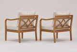 The two Savoca chairs seen from behind: the cross-back panels of bowed acacia bars, the beige back pillows and the curved arms