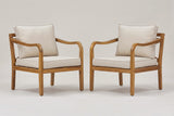 The two Savoca acacia club chairs with beige cushions, three-quarter view on a light studio backdrop