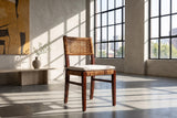 Scalea Rattan and Mahogany Dining Chair in a city loft