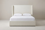 Scanno ivory canvas wingback bed with a white mattress and pillows (not included), front view
