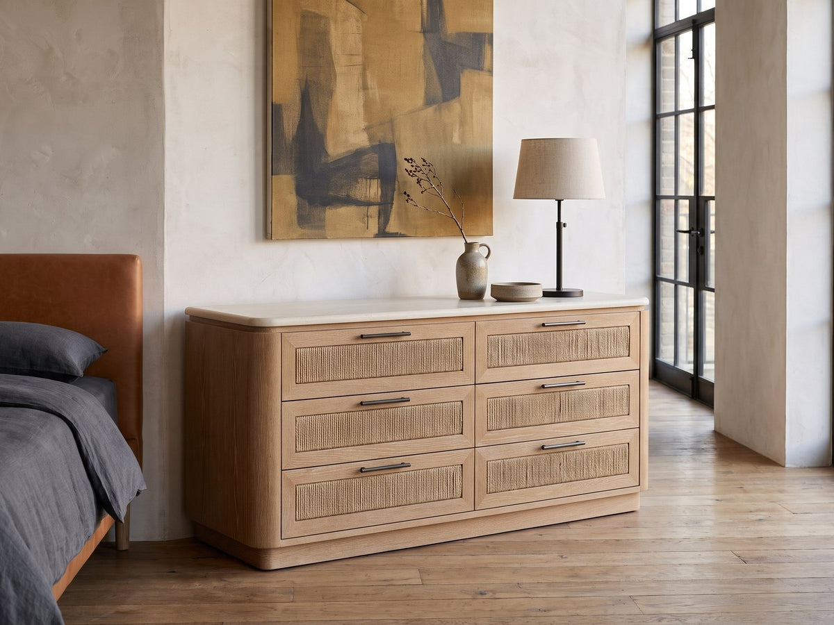 Schio 66.5-Inch Toffee 6-Drawer Dresser against a plaster wall in an industrial loft bedroom
