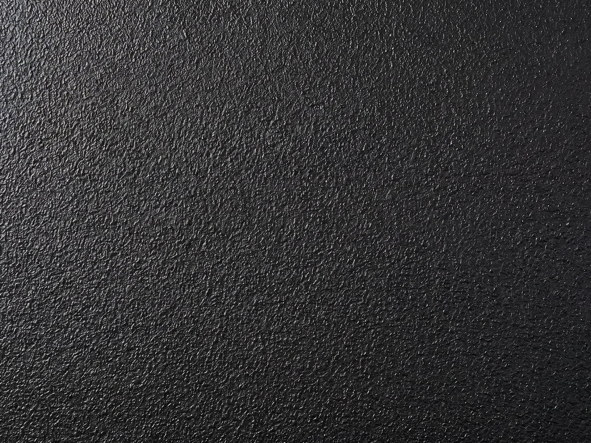 Close-up of the Scicli Black Fiberglass Pebble Coffee Table: the pebbled black finish of the fiberglass body