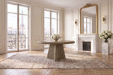 Scigliano 60-Inch Round Knotty Oak Veneer Pedestal Dining Table in a Paris salon