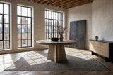 Scigliano 60-Inch Round Knotty Oak Veneer Pedestal Dining Table in a city loft