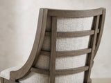 Close-up of the Scilla 75.5 to 95.5-Inch Sunburst Oak Extending Dining Set with 4 Armchairs: the wooden ladder back over the greige upholstery of a chair