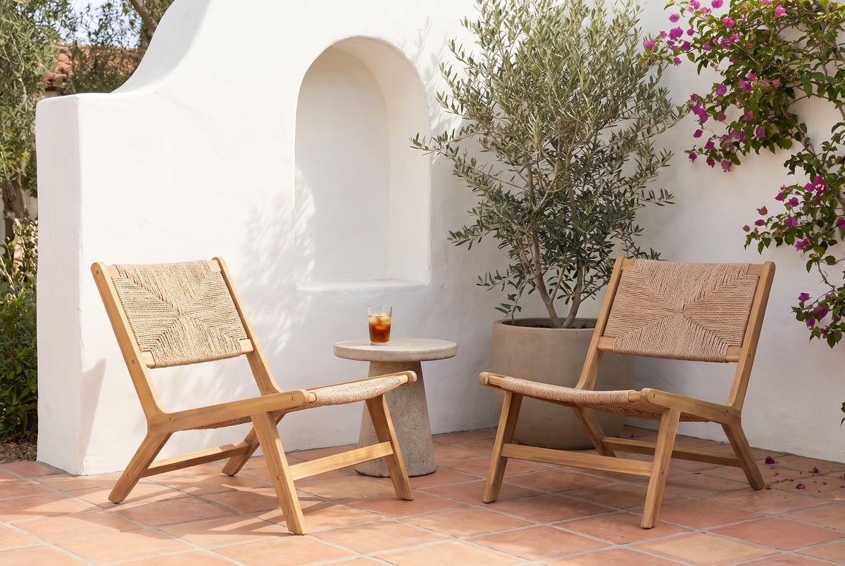 Two Scopello lounge chairs in a whitewashed Santa Barbara courtyard with an arched niche, an olive tree, bougainvillea and a terracotta tile floor (side table and drink not included)