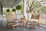 Two Scopello lounge chairs on a Savannah porch with a charcoal painted floor, grey-green beadboard ceiling, white columns and live oaks hung with Spanish moss (side table and drink not included)