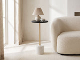 Seggiano Black Mango and Marble Drink Side Table with a lamp and a ceramic bowl beside a cream boucle armchair in a bright plaster room