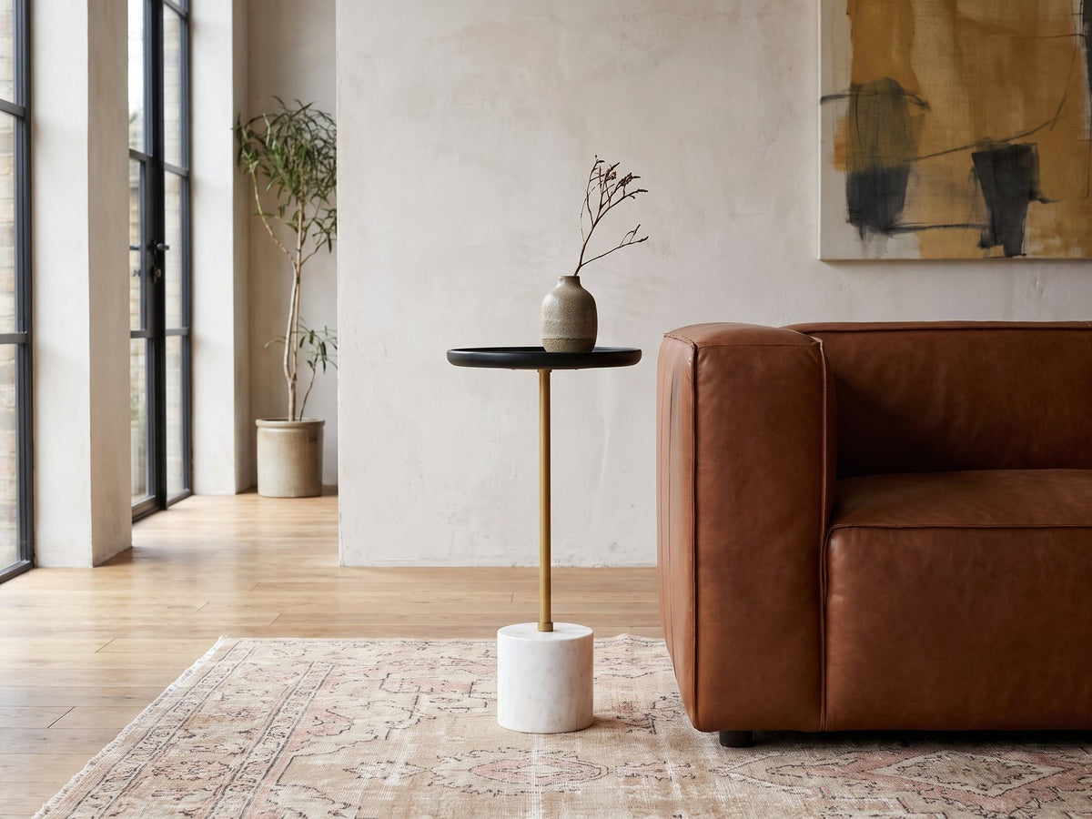 Seggiano Black Mango and Marble Drink Side Table beside a leather sofa in an industrial loft