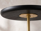 Close-up of the Seggiano Black Mango and Marble Drink Side Table: the rounded rim of the black mango top over the gold rod