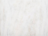 Close-up of the Seggiano Black Mango and Marble Drink Side Table: the white marble of the base