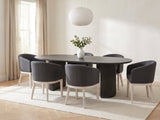 Seminara 80-Inch Oval Fluted Pedestal Dining Set with 6 Chairs in a bright plaster dining room with linen curtains